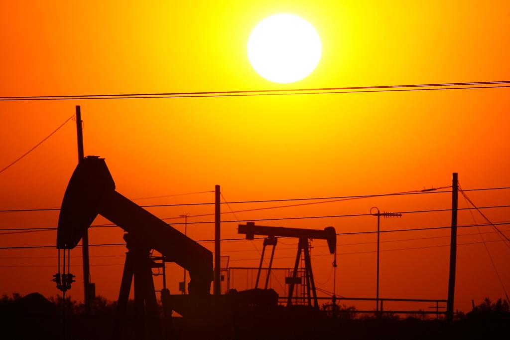 Oil rigs backlit by sunrise on July 22, 2008.