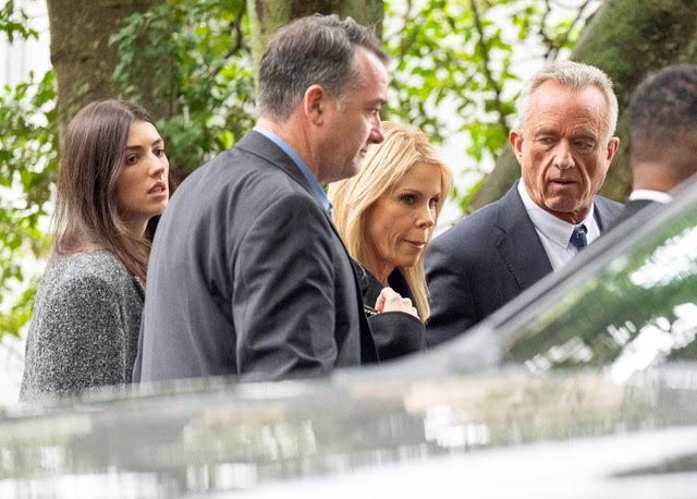 Kyra Kennedy, an unknown person, Cheryl Hines, and Robert F. Kennedy Jr. standing outside at Ethel Skakel Kennedy's funeral in Centerville, MA