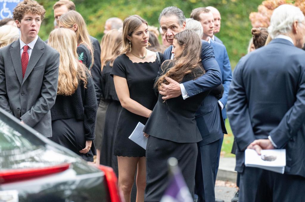 Former NYS governor Andrew Cuomo standing with unidentified women at Ethel Skakel Kennedy's funeral at Our Lady of Victory, Centerville, MA.