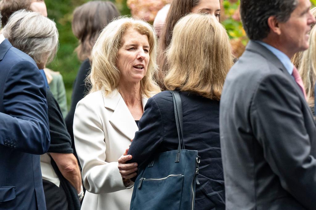 Rory Kennedy and Mark Shriver at the funeral of Ethel Skakel Kennedy at Our Lady of Victory, Centerville, MA, with a woman offering consolation to another.