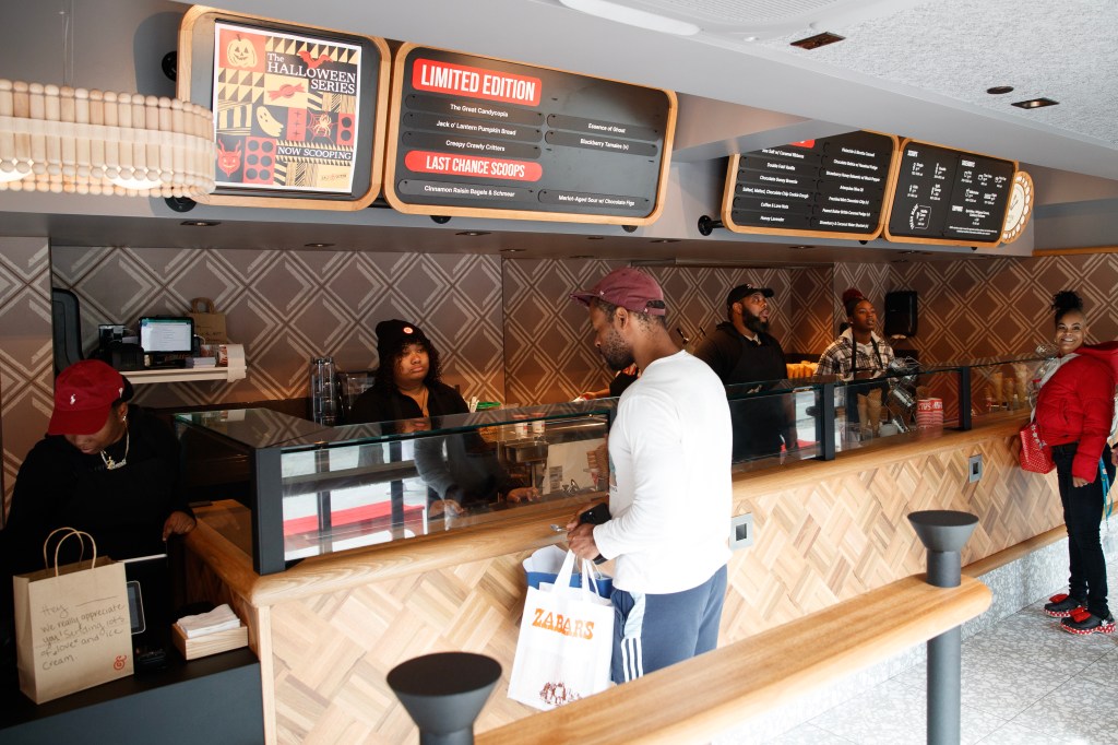 Counter with two customers at Salt & Straw ice cream in NYC. 