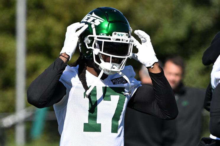 Jets wide receiver Davante Adams puts on his helmet during practice on Oct. 17, 2024.