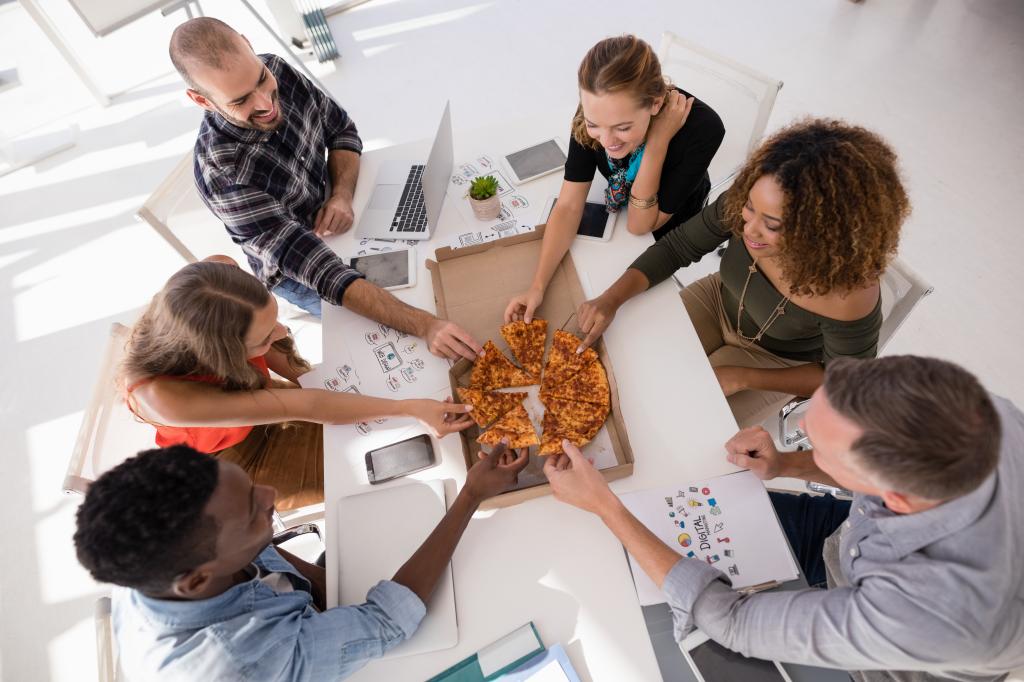 Coworkers sharing pizza. 