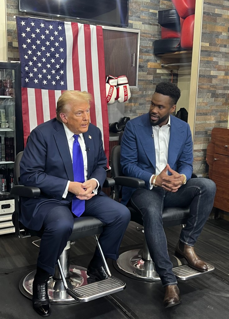 Former President Donald Trump and Fox Reporter Lawrence Jones sitting in barber chairs during an interview at Knockout Barbershop on Castle Hill Avenue, Bronx, NY