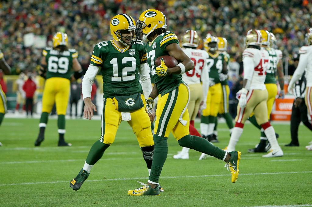 Aaron Rodgers #12 and Davante Adams #17 of the Green Bay Packers celebrate after scoring a touchdown in the first quarter against the San Francisco 49ers at Lambeau Field on October 15, 2018 in Green Bay, Wisconsin. 