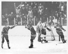 It was a tough night for Black Hawk goalie Denis DeJerdy. Here he looks on sadly after Vic Hadfield (left) converted pass from Rod Gilbert to score Rangers' first goal of the night. Jean Ratelle is on the right, while DeJordy is being consoled... March 04, 1968.