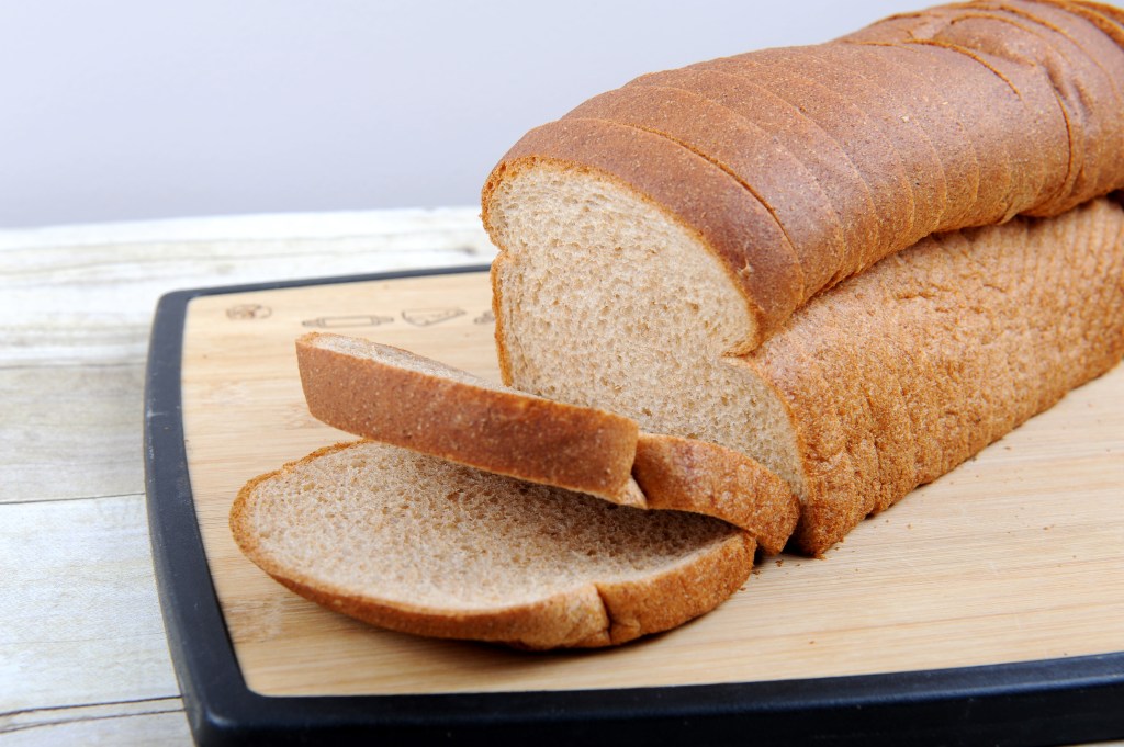 A sliced loaf of whole wheat bread.