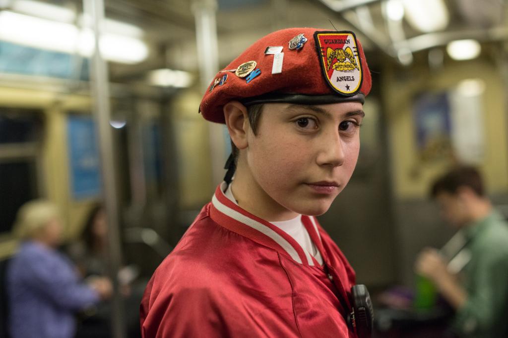 A boy wearing a red hat with the title Guardian Angel, Anthony Chester, NY, NY