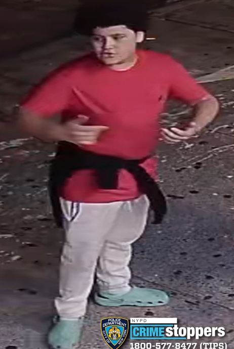 The third suspect shown in photos and video appears to be a teen wearing a red T-shirt, light colored pants, light colored slippers, and a black sweater tied around his waist.