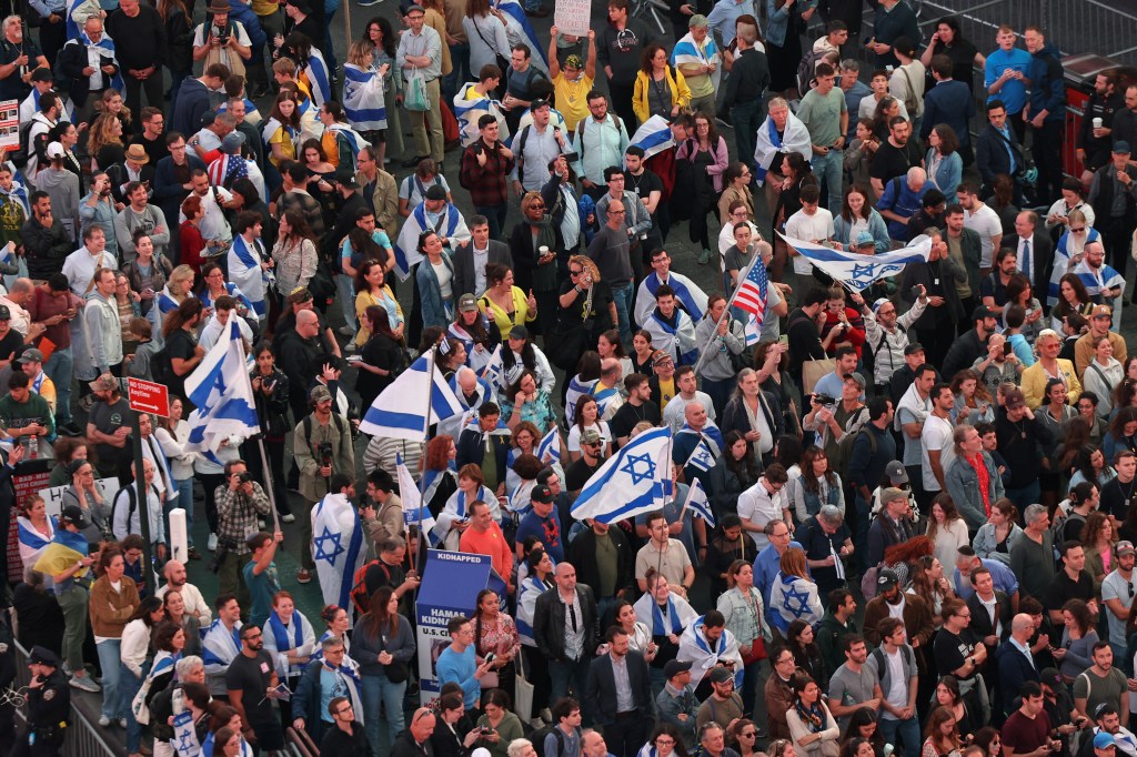 Large crowd of Israel supporters waving flags in Times Square, New York City, commemorating the October 7, 2023 attack in Israel