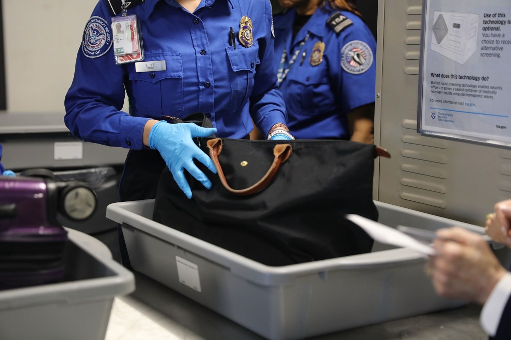 A Transportation Security Administration (TSA) worker screens luggage at LaGuardia Airport (LGA) on September 26, 2017 in New York City. 