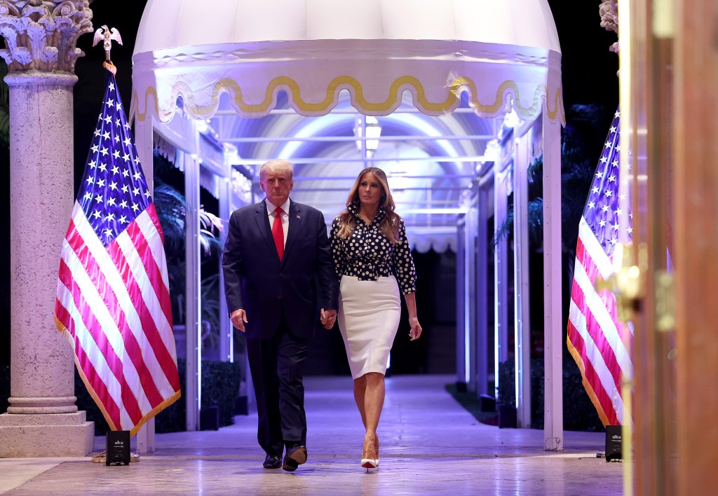 Former U.S. President Donald Trump and former first lady Melania Trump walking down a walkway at Mar-a-Lago, Palm Beach during the announcement of his 2024 presidential campaign.