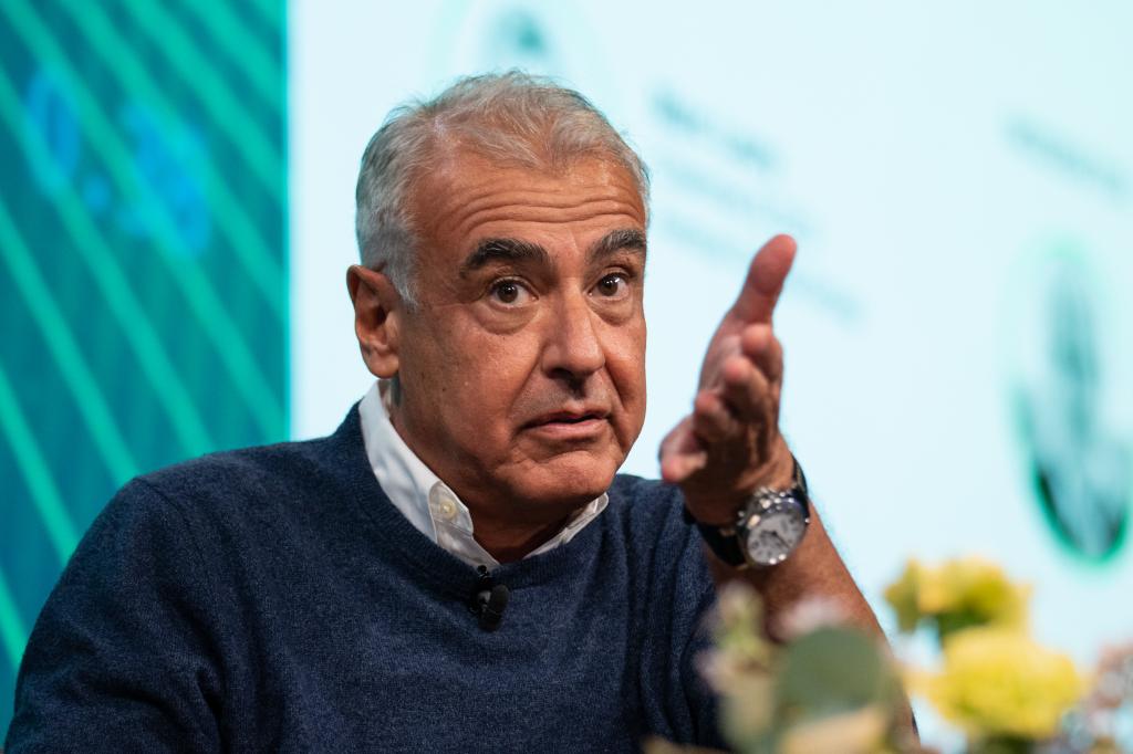 Marc Lasry sitting looking like he is pleading to the camera.