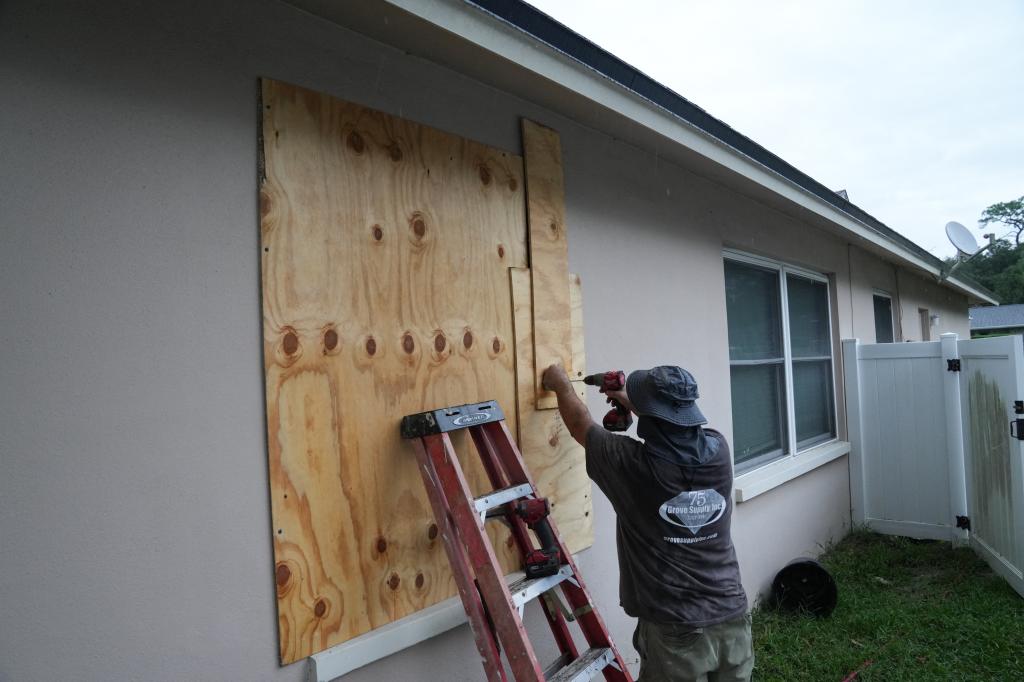 A resident boards up his windows in Palm Harbor, Florida, ahead of Hurricane Milton.