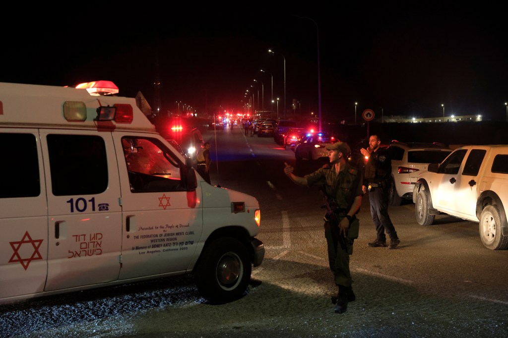 Emergency services personnel attend the scene of a drone strike on October 13, 2024 in Binyamina, Israel.