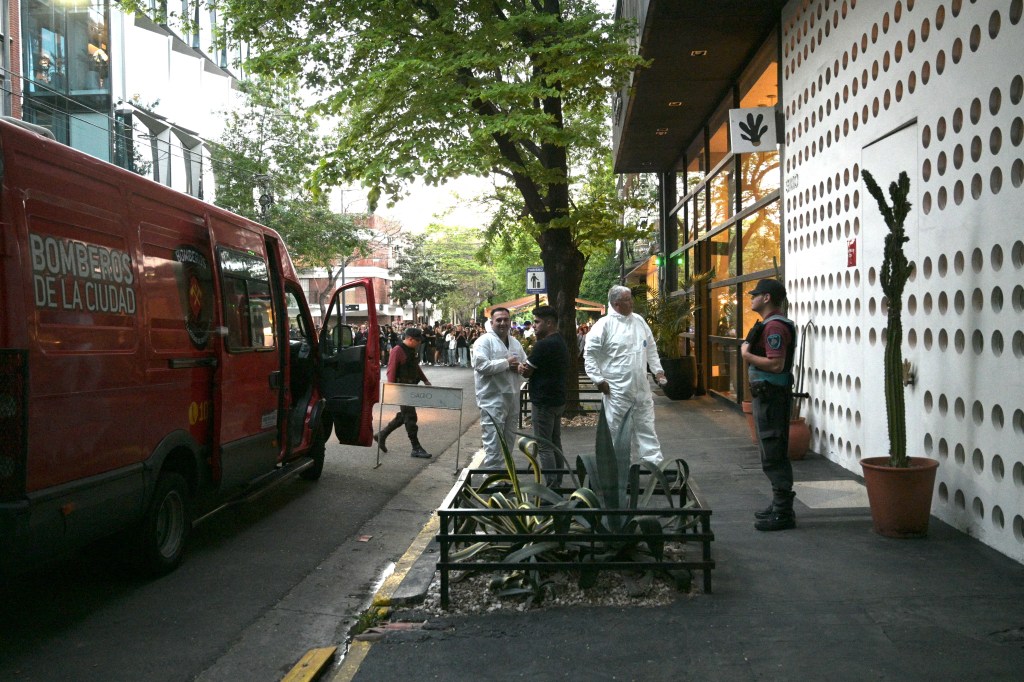 Forensic workers outside the hotel.