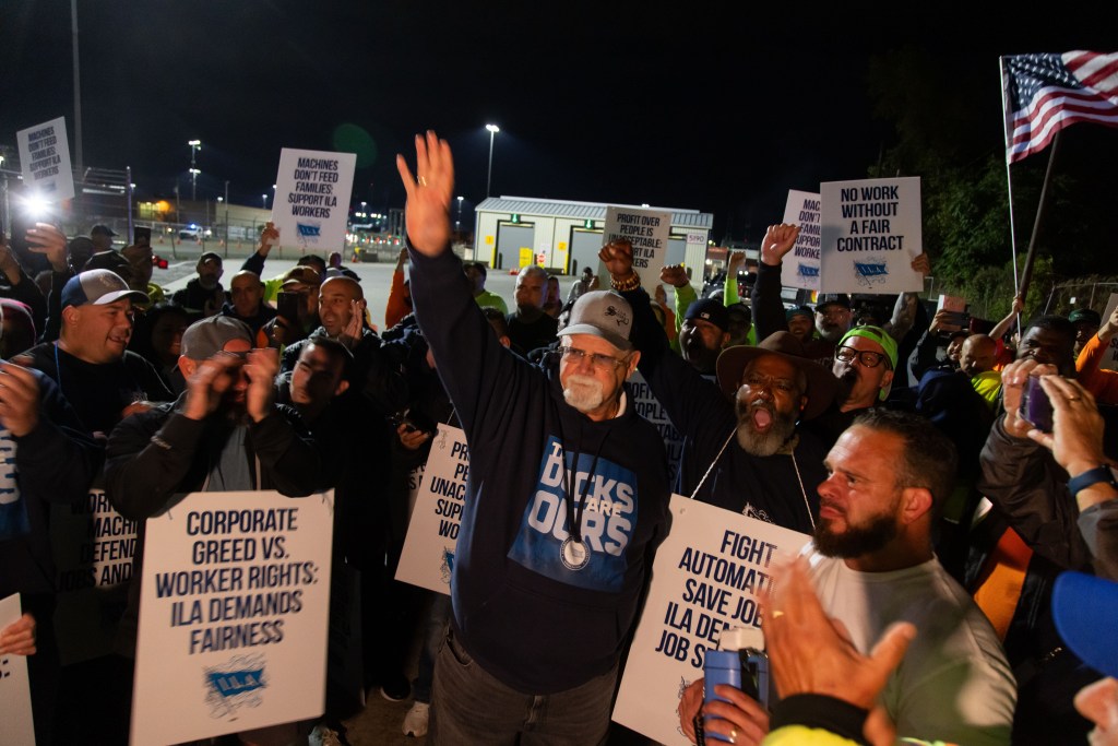 Harold Daggett with dockworkers picketing near Newark port.