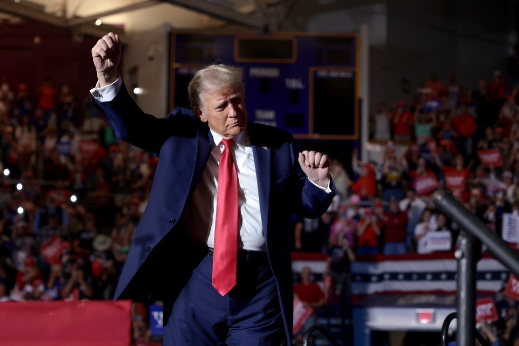 Republican presidential nominee, former U.S. President Donald Trump leaves the stage following a campaign rally at Williams Arena at Minges Coliseum on October 21, 2024 in Greenville, North Carolina.