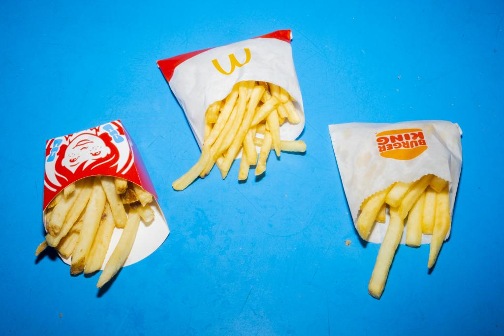 Small fries from Wendy's, McDonald's, and Burger King arranged in New York, US, symbolising the fast food price war