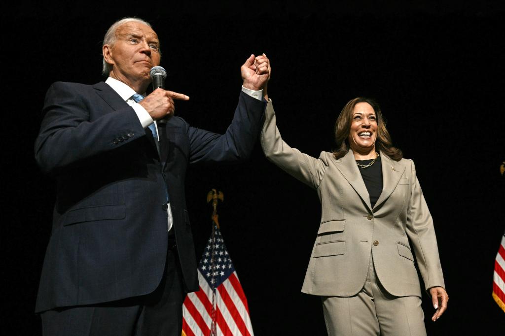 US President Joe Biden points to Vice President and Democratic presidential candidate Kamala Harris in the overflow room after they spoke at Prince George's Community College in Largo, Maryland, on August 15, 2024.