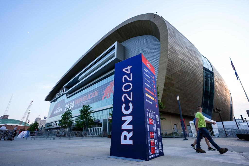 People walking outside the Fiserv Forum building ahead of the 2024 Republican National Convention in Milwaukee