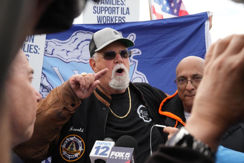 Harold Daggett speaks as dockworkers picket.