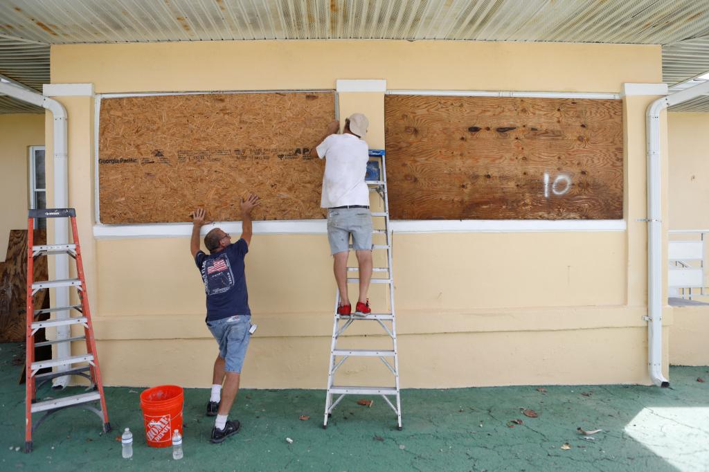 People boarding up a house in St. Pete Beach before the arrival of Milton on Oct. 7, 2024.