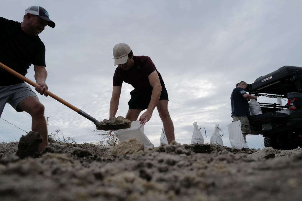 People in St. Petersburg filling up bags of sand on Oct. 8, 2024.