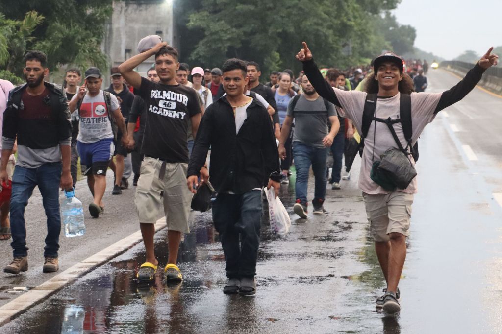 Migrants walk in a caravan