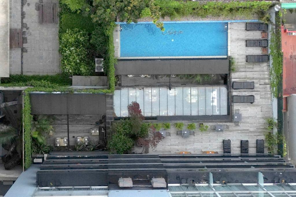 Aerial view of the hotel poolside area in Buenos Aires where British singer Liam Payne died, surrounded by trees and plants