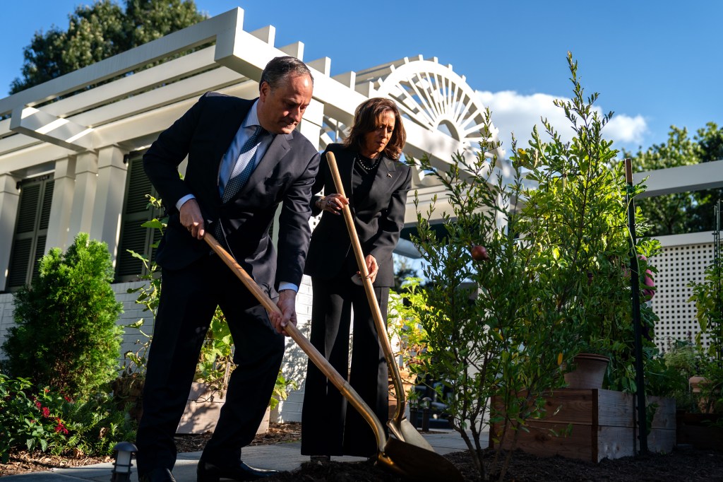 Second Gentleman Doug Emhoff and Vice President Kamala Harris plant a pomegranate tree at the Vice President's residence at the U.S. Naval Observatory on October 7, 2024 in Washington, DC.