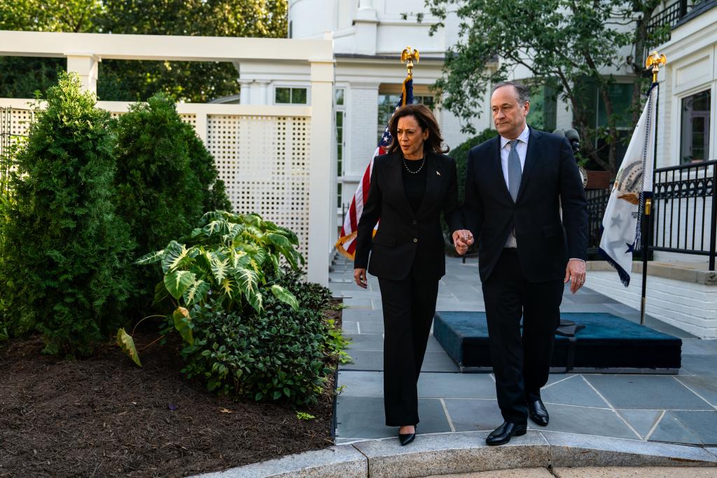 Vice President Kamala Harris and Second Gentleman Doug Emhoff walk over to plant a pomegranate tree at the Vice President's residence at the U.S. Naval Observatory on October 7, 2024 in Washington, DC.