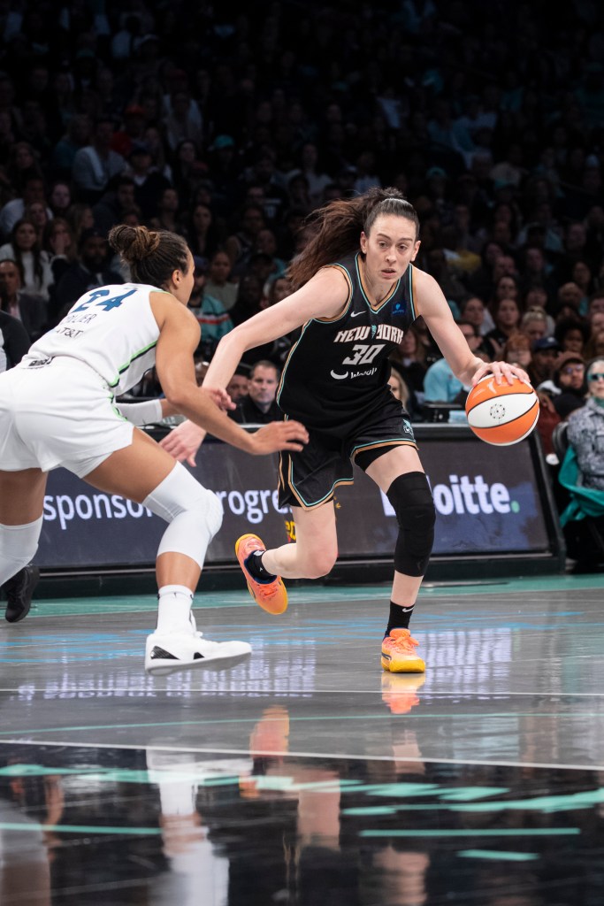 Breanna Stewart (30) of the Liberty dribbles against the Lynx's Napheesa Collier (24) during Game 5 of the WNBA Finals on Oct. 20, 2024.