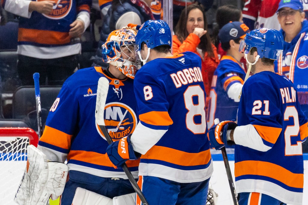 New York Islanders goaltender Semyon Varlamov (40) celebrates with New York Islanders defenseman Noah Dobson (8) after making the final block on a Montreal Canadiens defenseman Logan Mailloux (24) shot for the win during the shootout period at UBS Arena, Saturday, Oct. 19, 2024, in Elmont, NY.