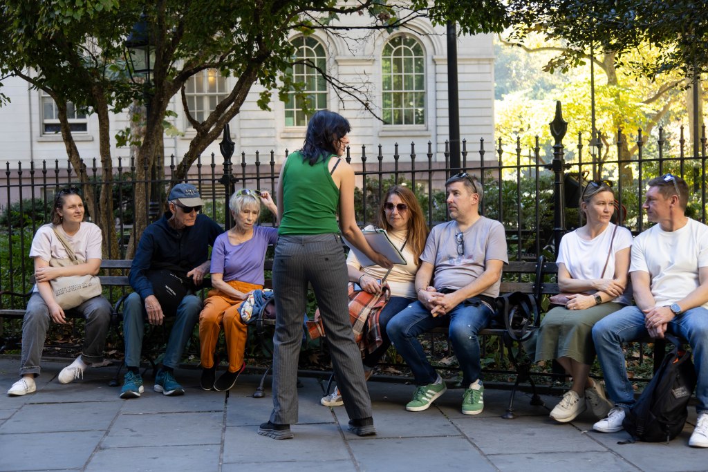 K. Krombie, tour guide at Purefinder and author of Death in New York: History and Culture of Burials, Undertakers and Executions, leads her Death in New York tour stopping at City Hall Park on October 20, 2024 in New York City.