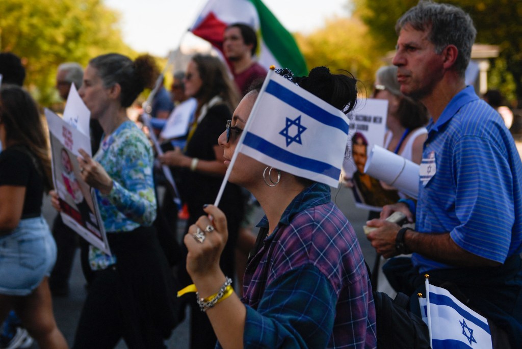 Pro-Israeli protesters march from the Washington Monument to the White House during a Philos Stand With Israel rally in Washington, DC, on October 7, 2024. 