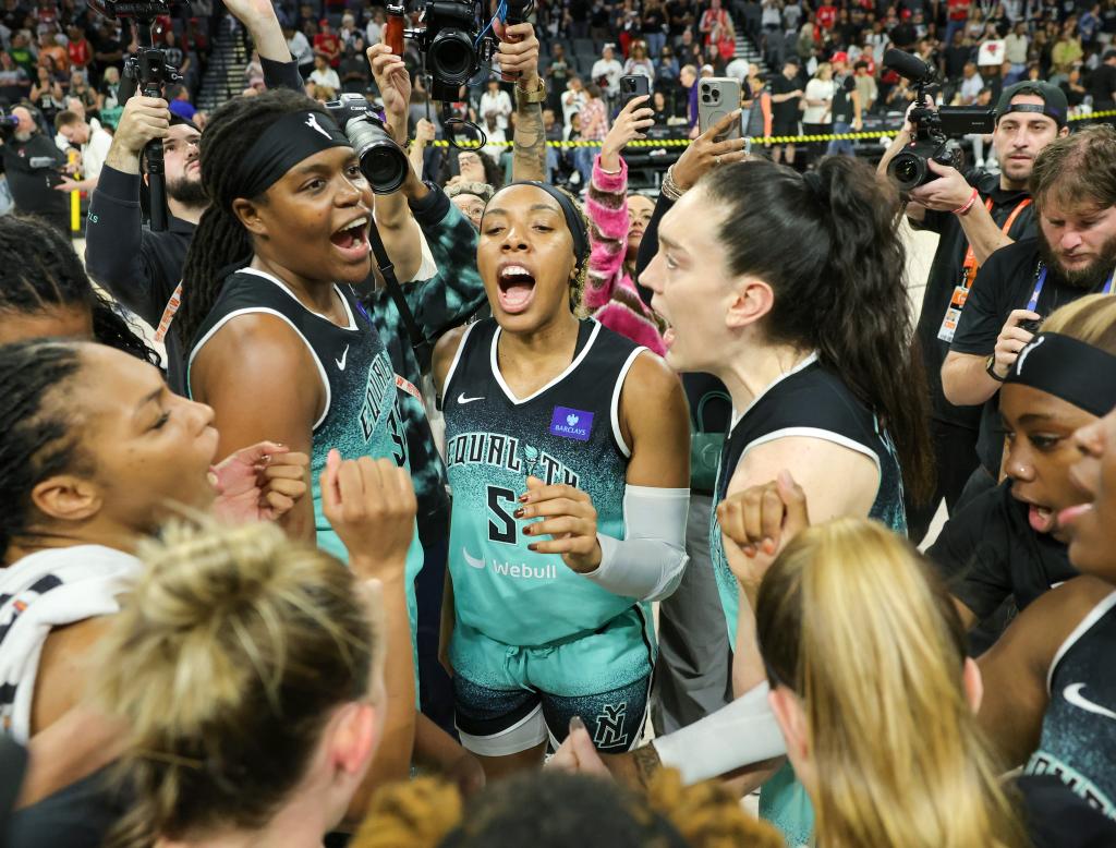 The New York Liberty, including (L-R) Jonquel Jones #35, Kayla Thornton #5 and Breanna Stewart #30, celebrate on the court after defeating the Las Vegas Aces 76-62 in Game Four of the 2024 WNBA Playoffs semifinals to win the series three games to one at Michelob ULTRA Arena on October 06, 2024 in Las Vegas, Nevada.