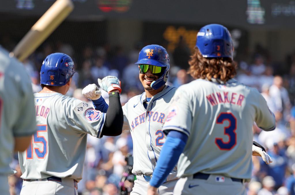 NLCS game 2: Mark Vientos #27 of the New York Mets is greeted by Tyrone Taylor #15 of the New York Mets after he scores on his grand slam during the second inning.