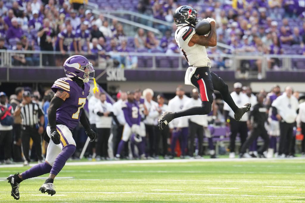 Tank Dell #3 of the Houston Texans catches a pass in front of Byron Murphy Jr. #7 of the Minnesota Vikings