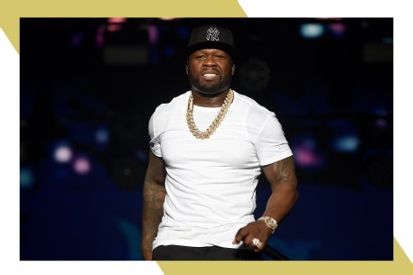 50 Cent smiles at the crowd while performing in concert.