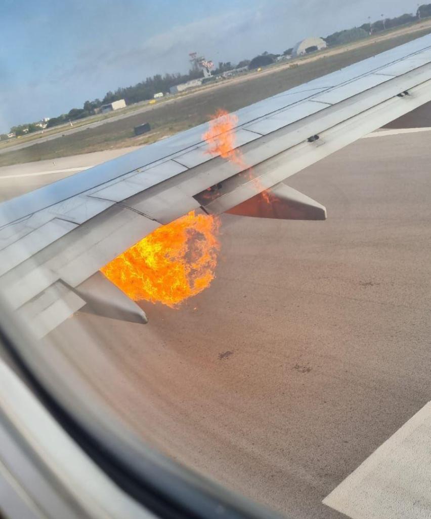 A Boeing jet with nearly 200 people onboard was evacuated in Italy early Thursday after flames were seen shooting from an engine.