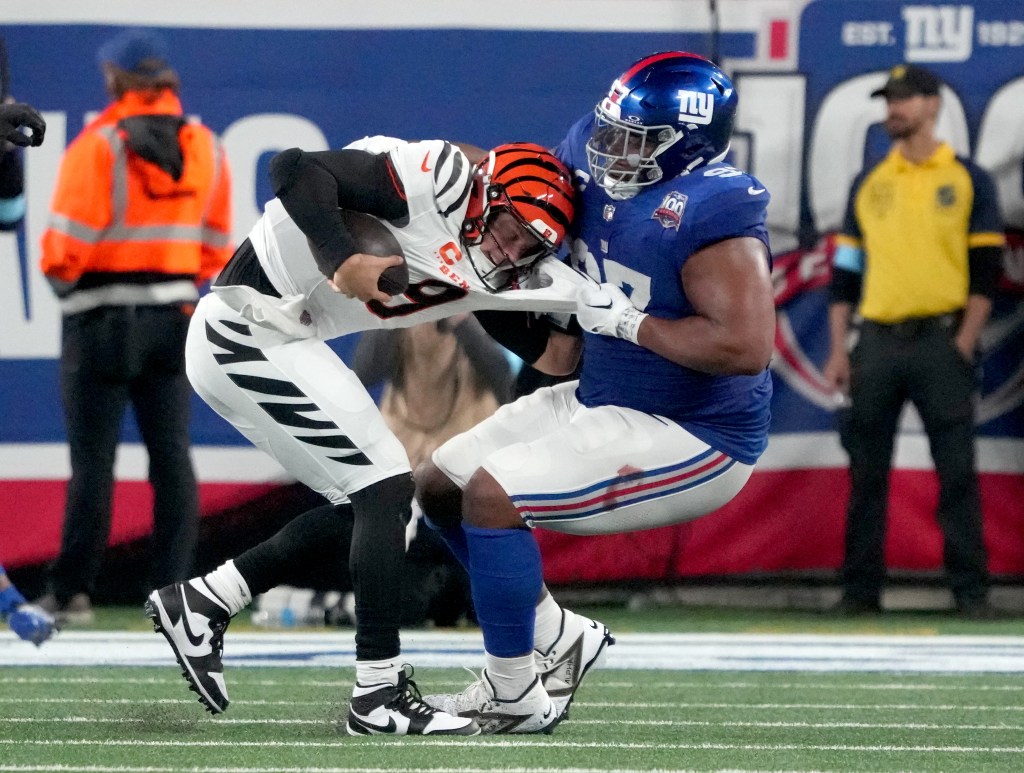 Bengals quarterback Joe Burrow (9) is sacked by New York Giants defensive tackle Dexter Lawrence II.