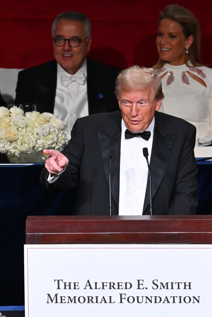 Donald Trump in a tuxedo giving a speech at the 2024 Al Smith Dinner, with an audience of notable figures like Martha MacCallum and others present.