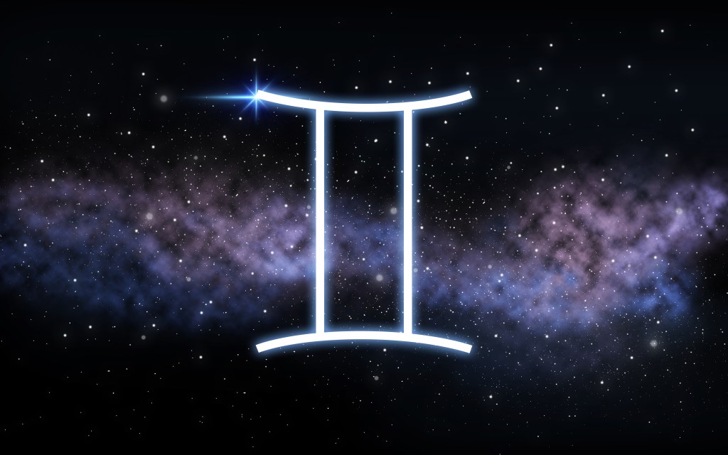 Gemini zodiac sign symbol illuminated against a dark starlit night sky with distant galaxy