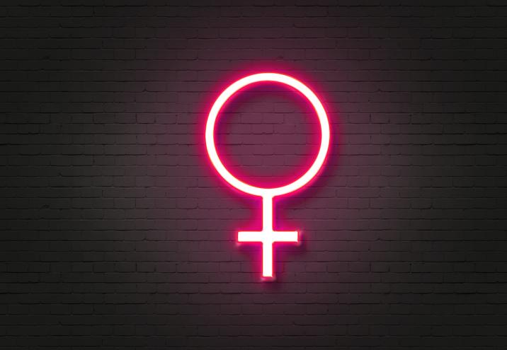 Male and female symbols on blue and pink neon signs