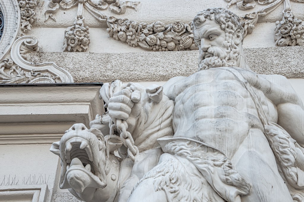 Closeup of outdoor statue of Hercules fighting the multi-headed dog, Cerberus, at Hofburg Palace in Vienna, Austria