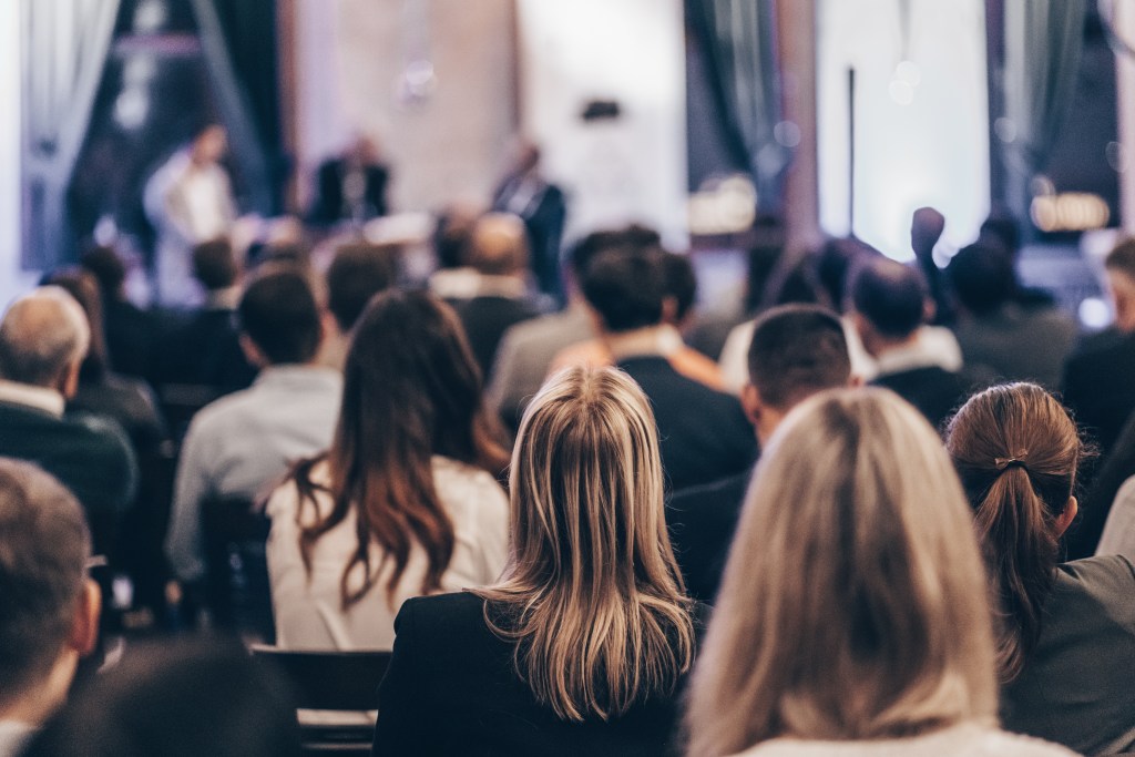 Business professionals engaged in a round table discussion at a conference event