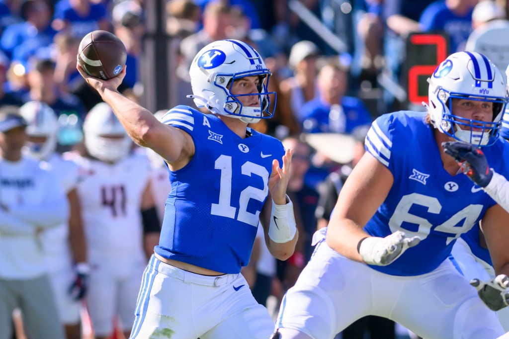 BYU quarterback Jake Retzlaff, left, looks to throw during an NCAA college football game against Arizona, Saturday, Oct. 12, 2024, in Provo, Utah. 