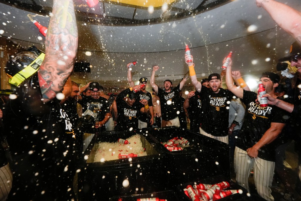 San Diego Padres players celebrate in the dugout after defeating the Atlanta Braves in Game 2 of an NL Wild Card Series baseball game Wednesday, Oct. 2, 2024, in San Diego. 