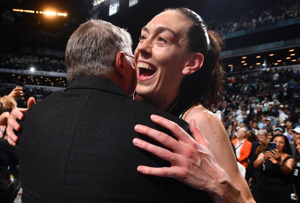 Breanna Stewart hugs Geno Auriemma after the Liberty's Game 2 win over the Lynx in the WNBA Finals.